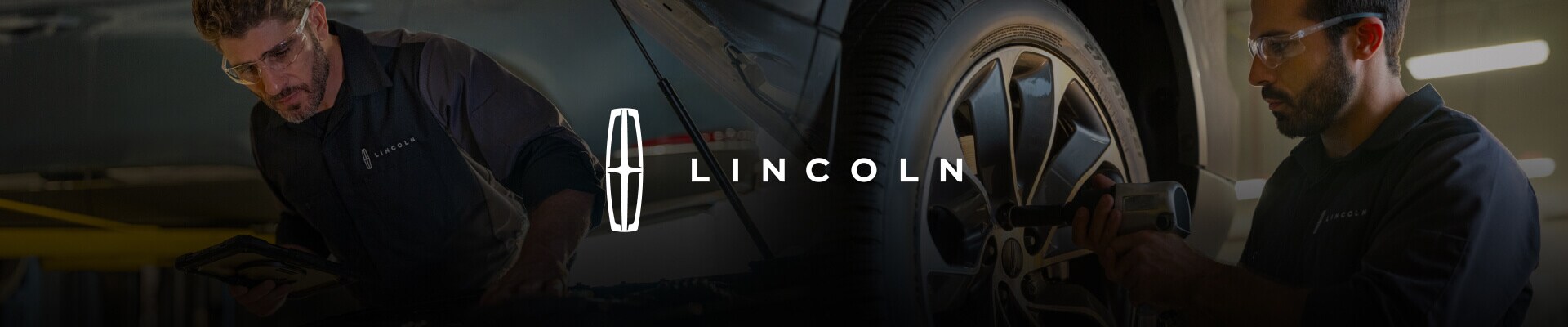 Two Lincoln Service Technicians replacing a Lincoln tire and running diagnostics under a hood.