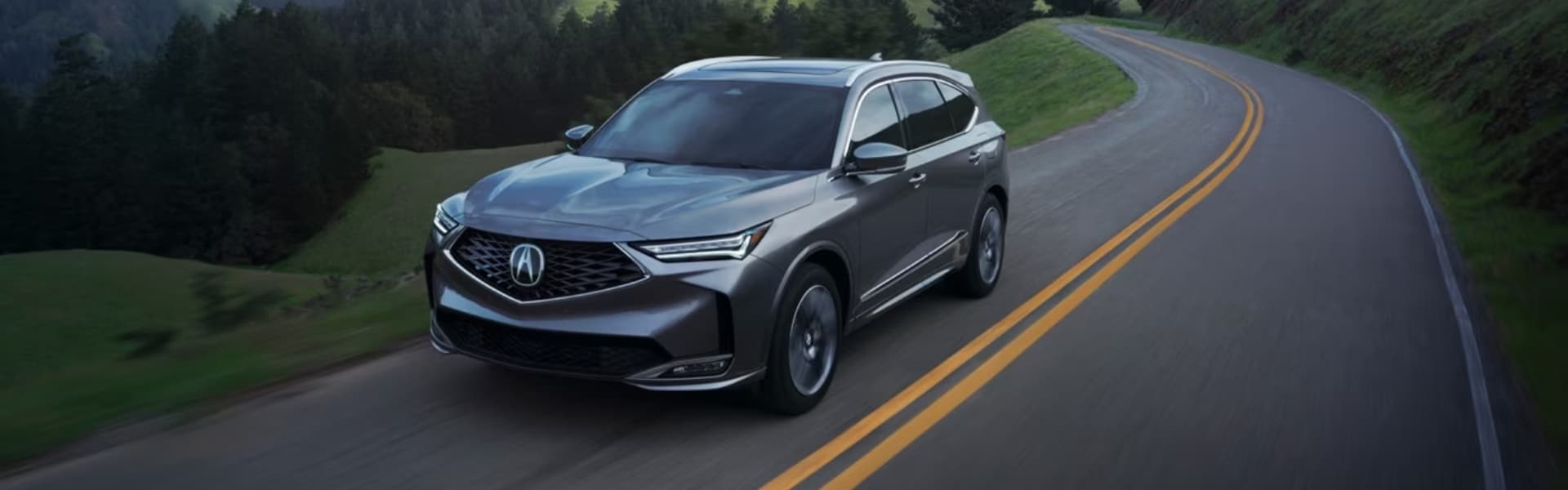 Black Acura MDX on road