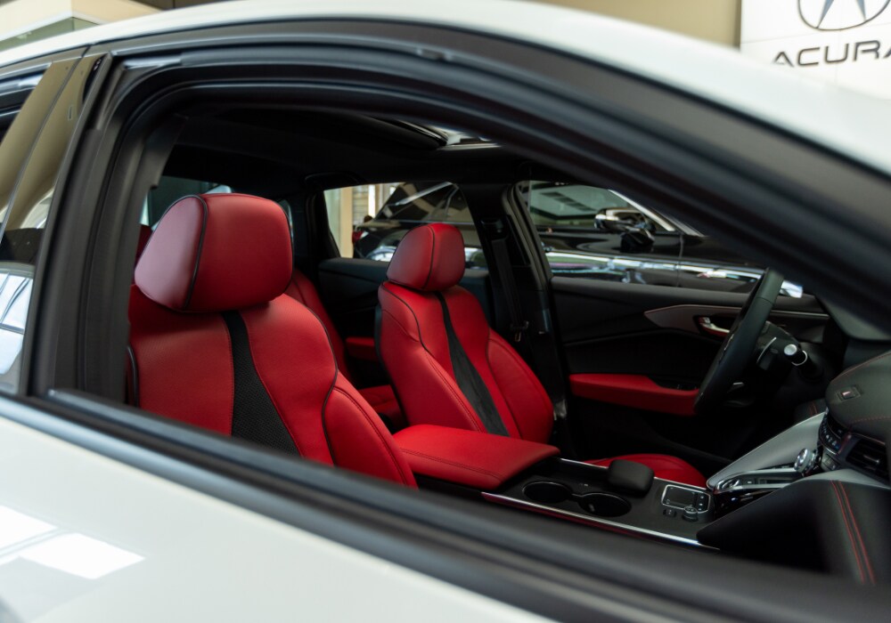 acura-dealership-serving-myrtle-beach.png Interior of an Acura sedan. The seats are bright red leather