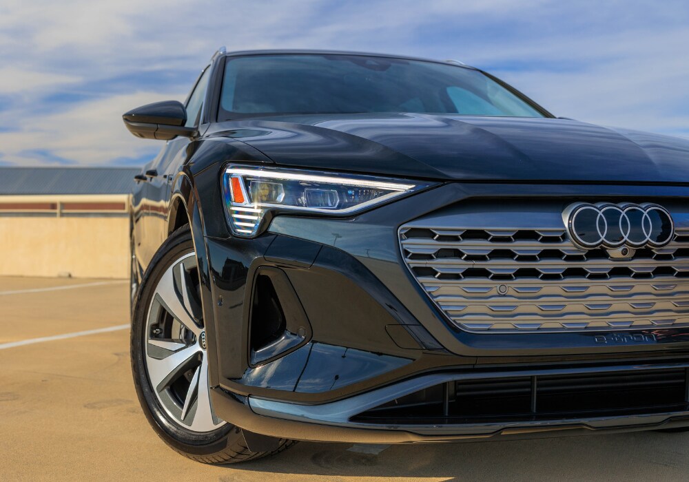 Close up image of a 2024 Audi Q8 e-tron. The Audi logo is visible on the front grille of the SUV