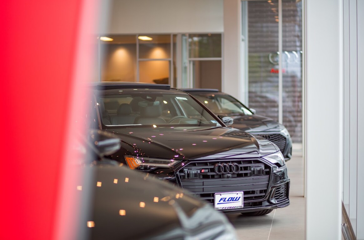 flow-audi-charlottesville-showroom.png Black Audi sedan parked inside the showroom of the Audi Charlottesville dealership in Charlottesville, Virginia