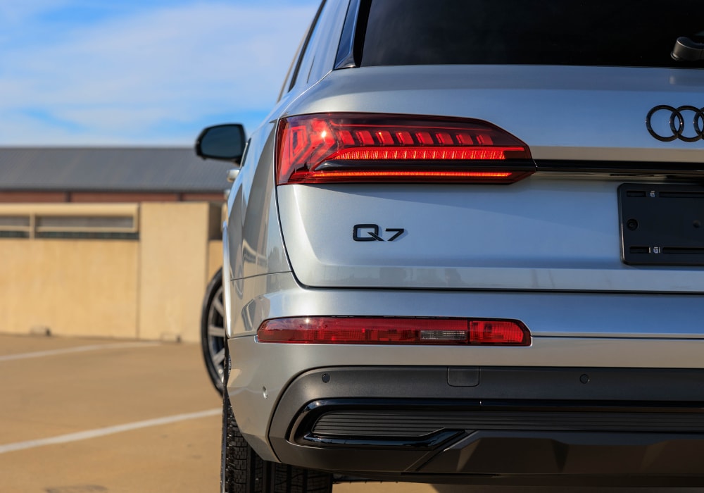 Close up shot of the rear of a 2024 Audi Q7 with the Audi logo visible. The right half of the car is out of frame