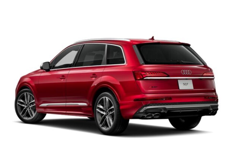 audi-sq7-for-sale.png A red 2025 Audi SQ7 SUV parked in front of a white background. The SUV is facing the right side of the image and shows the rear of the vehicle, including the taillights, spoiler, and dual exhaust tips.