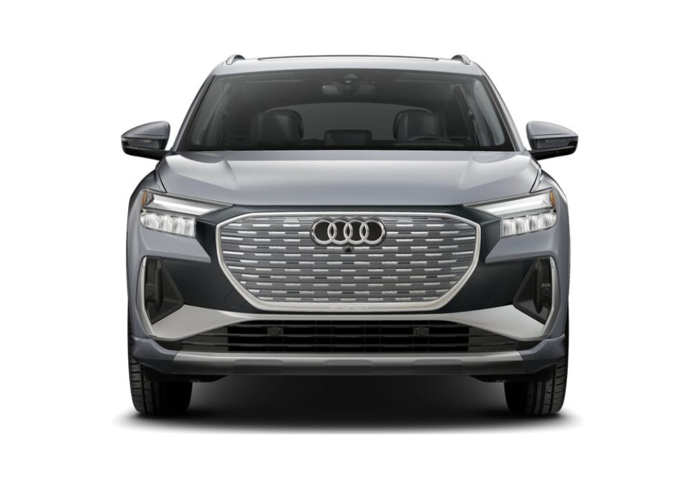 2024-audi-q4-etron.png A front view of a gray 2024 Audi Q4 e-tron electric SUV. It has a sleek, modern design with LED headlights, a large grille with chrome accents, and a closed-off front end typical of electric vehicles.