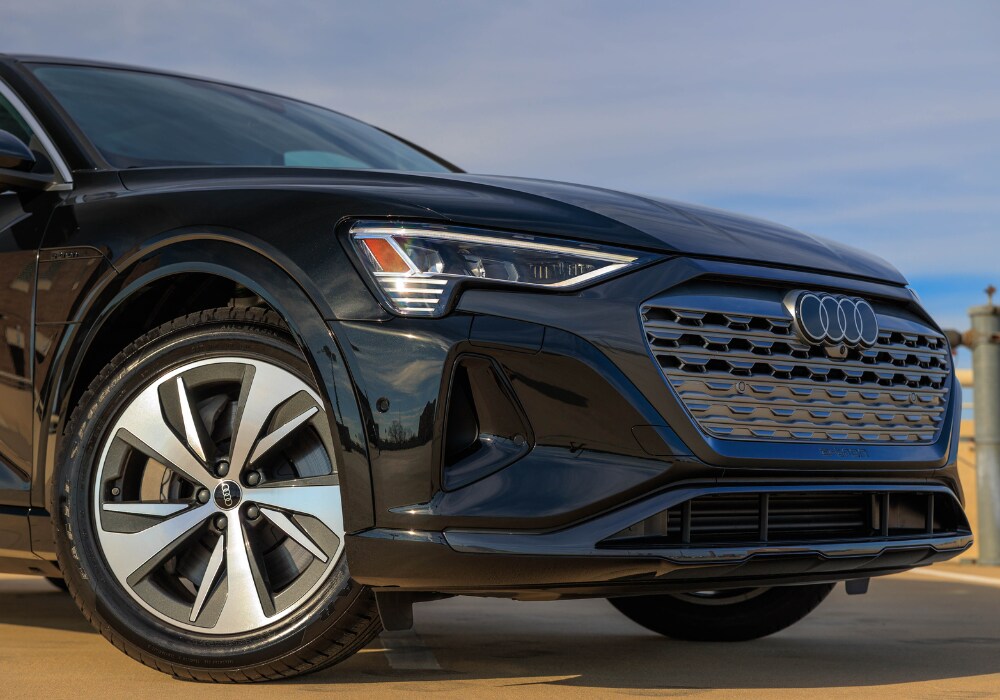 2024-audi-q8-e-tron-specs.png Close up shot of a 2024 Audi Q8 e-tron for sale in Greensboro. Image shows the front grille of the vehicle with the Audi logo visible