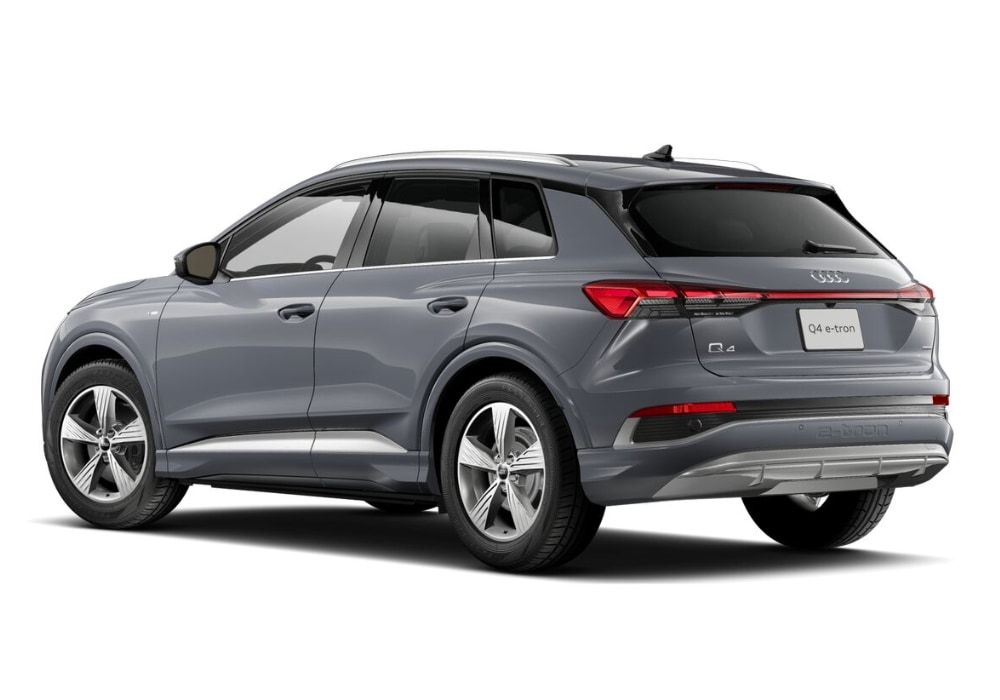 audi-e-tron-q4.png A rear view of a gray 2024 Audi Q4 e-tron electric SUV. It shows the car's sleek lines, LED taillights, and the