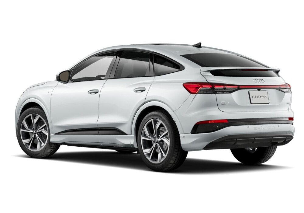audi-sportback-e-tron-for-sale.png A rear view of a white 2024 Audi Q4 Sportback e-tron, showcasing its sleek and sporty design with large wheels, black accents, and a rear spoiler.