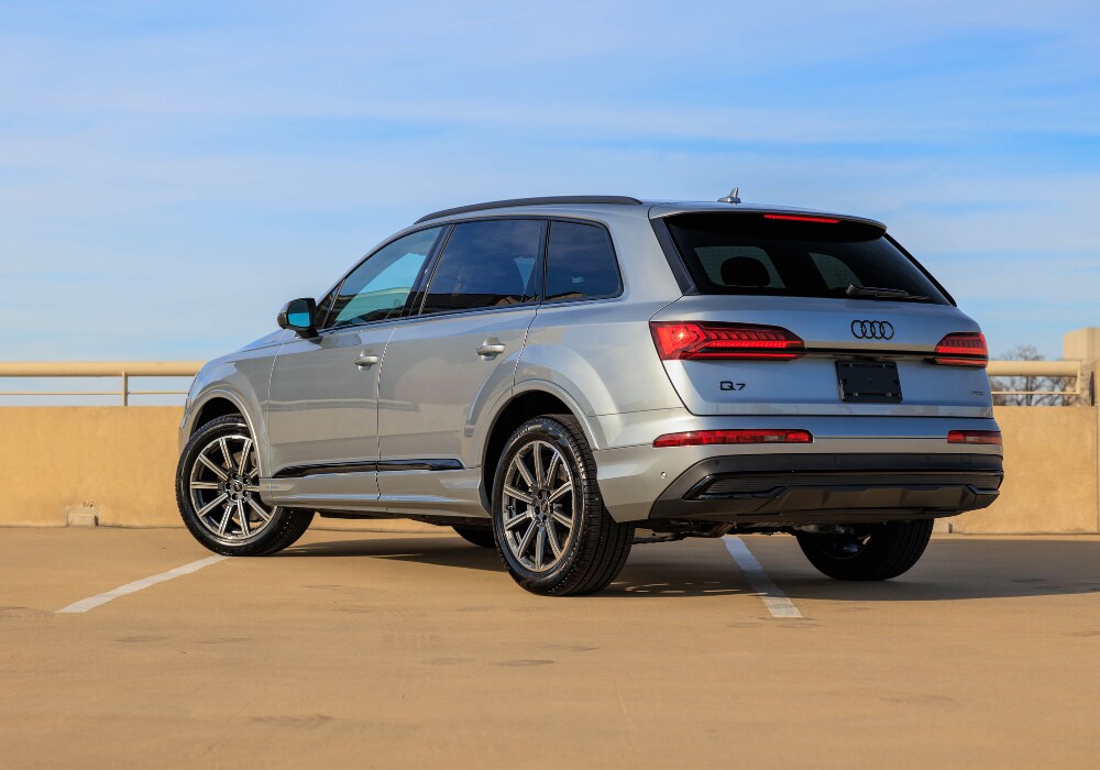 2024-audi-q7-greensboro.png Image shows a new Audi Q7 for sale in Greensboro. the SUV is facing away from the camera and the Audi logo is visible on the back of the car