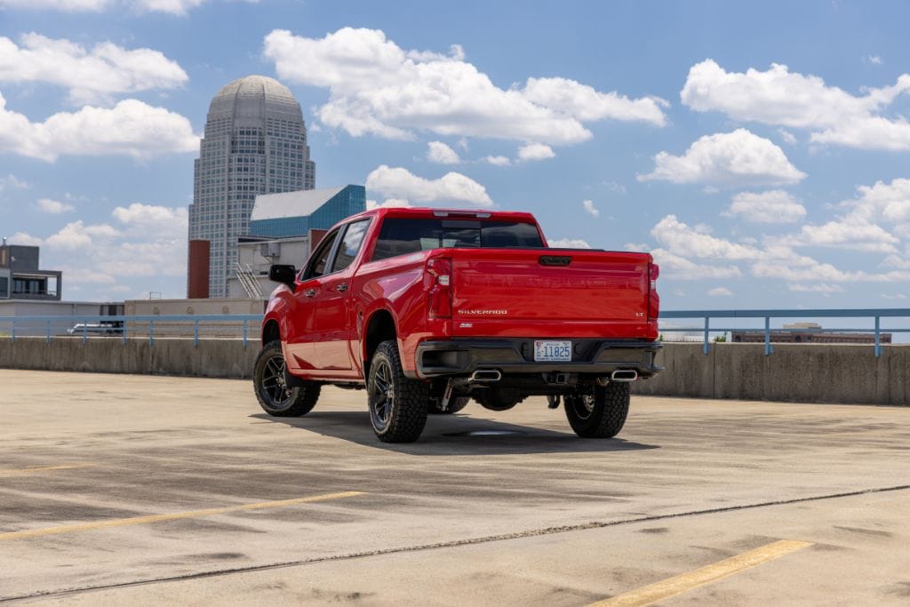 2024-chevy-silverado-1500.jpg Rear view of red 2024 Chevy Silverado truck for sale in Winston-Salem, NC parked on top of a downtown parking deck
