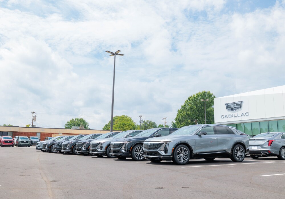 cadillac-certified-pre-owned-inventory.png Lineup of Cadillac cars parked outside the Flow Cadillac dealership in Winston-Salem, NC