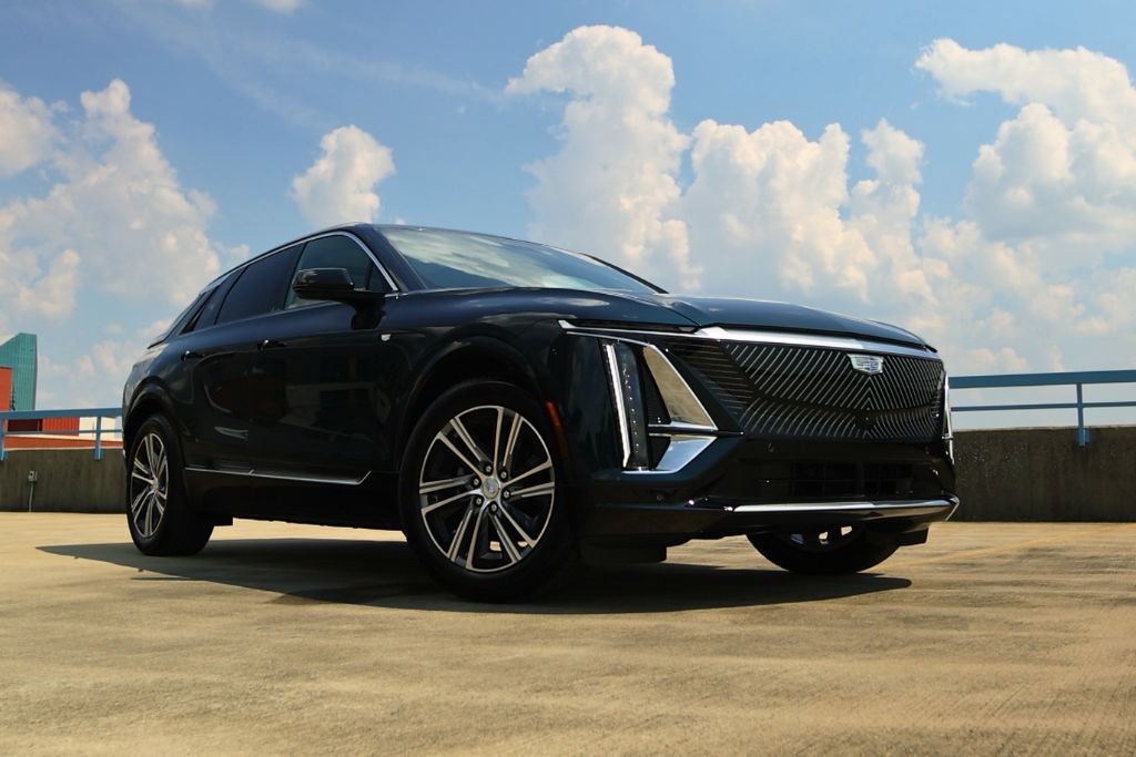 cadillac-lyriq-electric-vehicle.jpg Front passenger side view of the Cadillac Lyriq parked on top of parking a deck with Winston-Salem skyline in background