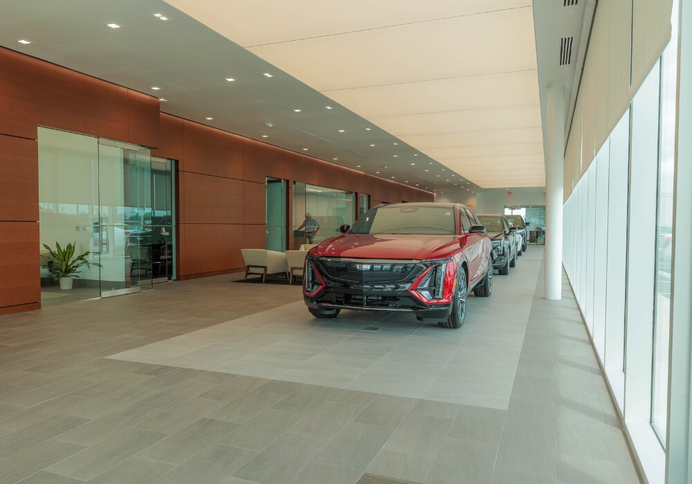 cadillac-cars-for-sale-winston-salem-nc.png Showroom interior of Flow Cadillac. There are several Cadillac SUVs parked inside the dealership