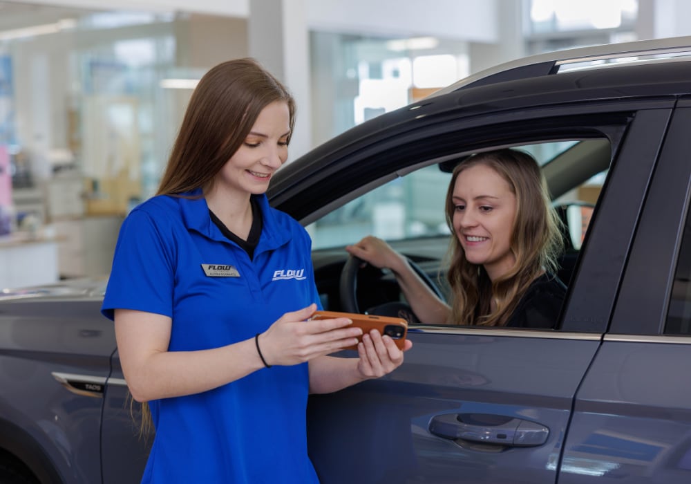 used-suvs-for-sale-winston-salem.png A Flow BMW employee assisting a customer while the customer sits inside a BMW