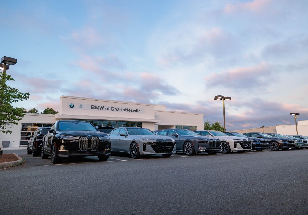 bmw-executive-demo-charlottesville-va.png A lineup of BMW cars for sale parked outside the BMW of Charlottesville dealership