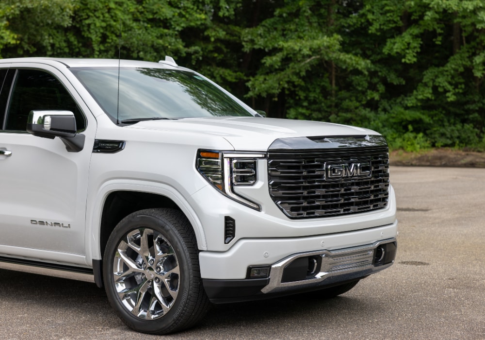 gmc-sierra-1500-fayetteville.png Front shot of a white 2024 GMC Sierra Denali