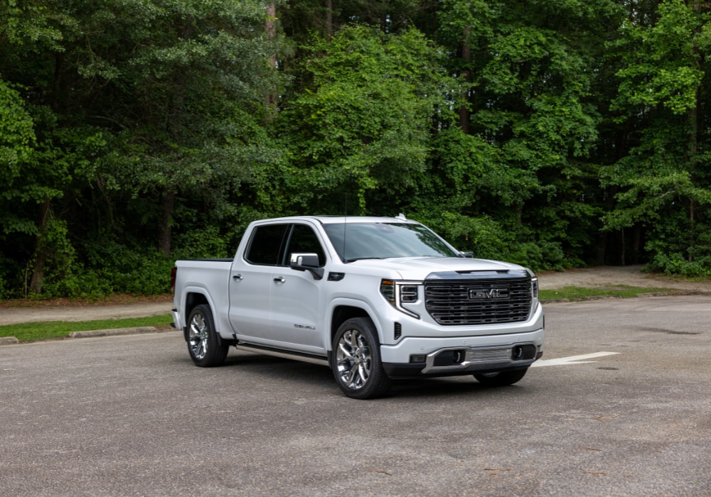 gmc-sierra-1500-pickup-truck.png 2024 GMC Sierra 1500 Denali pickup truck parked in a lot