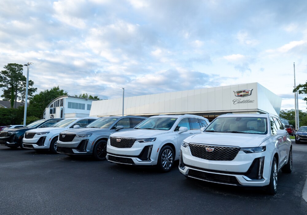 cadillac-dealership-serving-myrtle-beach.png Lineup of Cadillac SUVs parked outside of the Flow Cadillac of Wilmington dealership