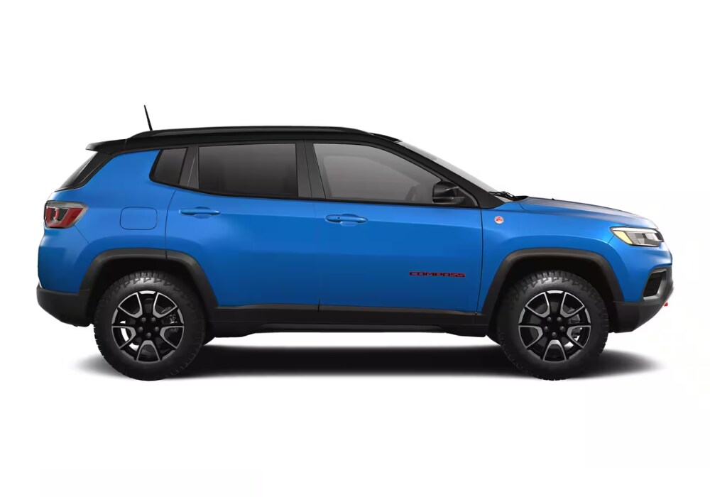 jeep-compass-for-sale-charlottesville.png Side view of a bright blue Jeep Compass in front of a white background