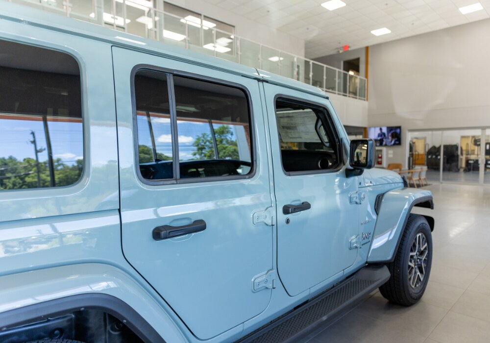 jeep-demo-cars-for-sale.png Jeep Wrangler for sale in Charlottesville. The car is blue and the photo shows the exterior passenger side