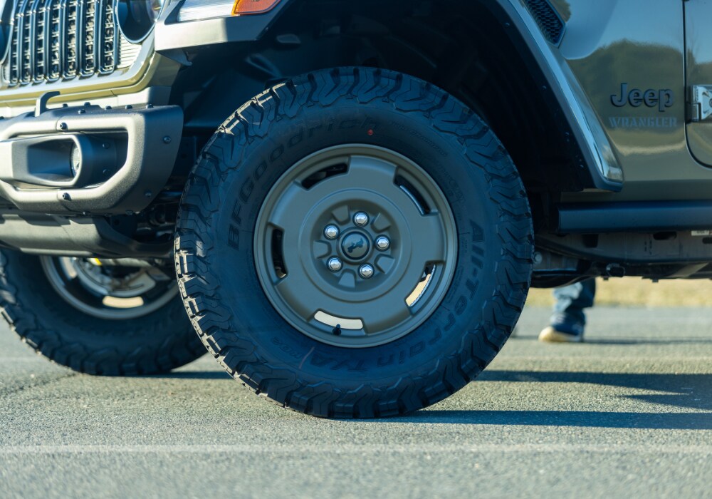 jeep-wrangler-4x4.png Close up photo of the front tire of a Jeep Wrangler for sale in Charlottesville