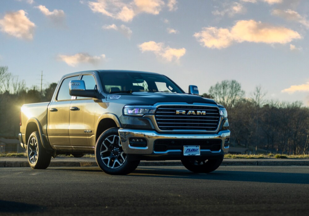 ram-1500-for-sale-charlottesville-va.png new Ram 1500 truck parked in an empty lot with a trees in the background