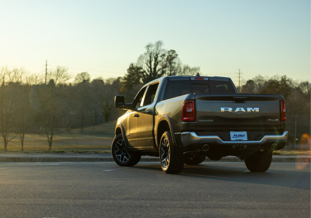 2025-ram-1500-towing-capacity.png 2025 Ram 1500 parked with the rear of the truck facing the camera. The Flow logo is visible on license plate
