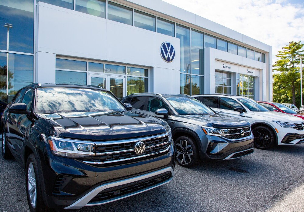 volkswagen-demo-vehicles-burlington-nc.png Lineup of Volkswagen cars for sale parked outside the Flow Volkswagen of Burlington dealership