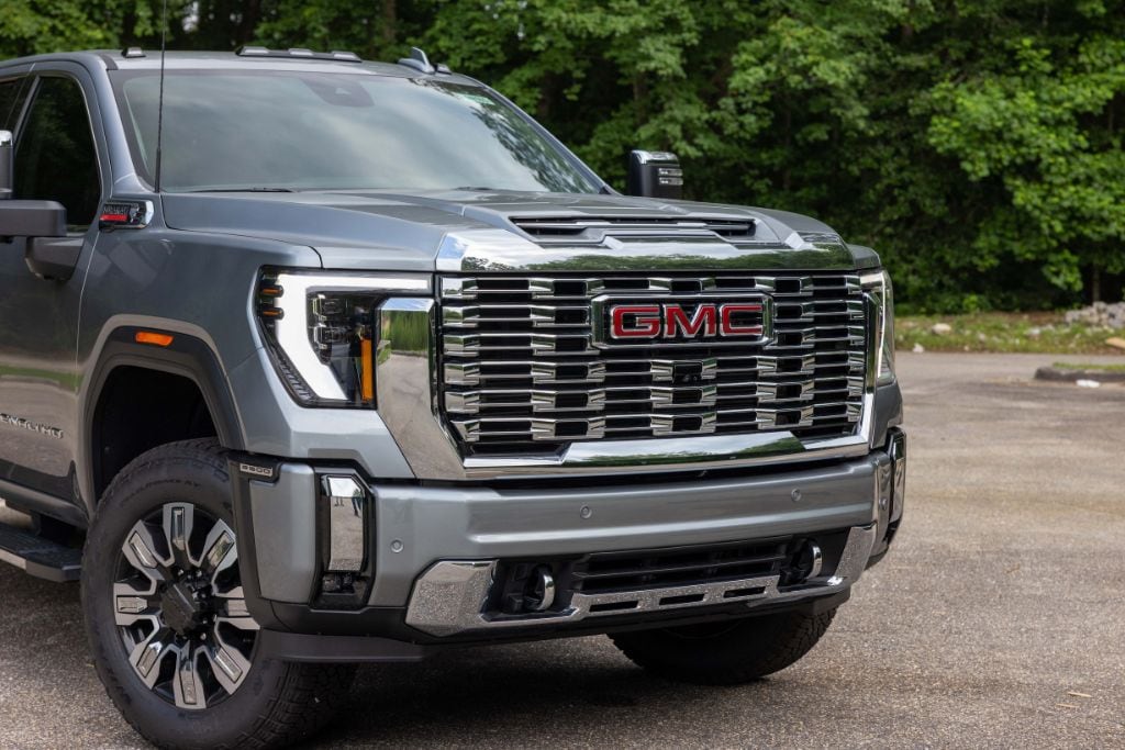 2024-gmc-sierra-2500-for-sale.jpg Front shot of a gray 2024 GMC Sierra 2500. The front grille is silver with a red GMC logo