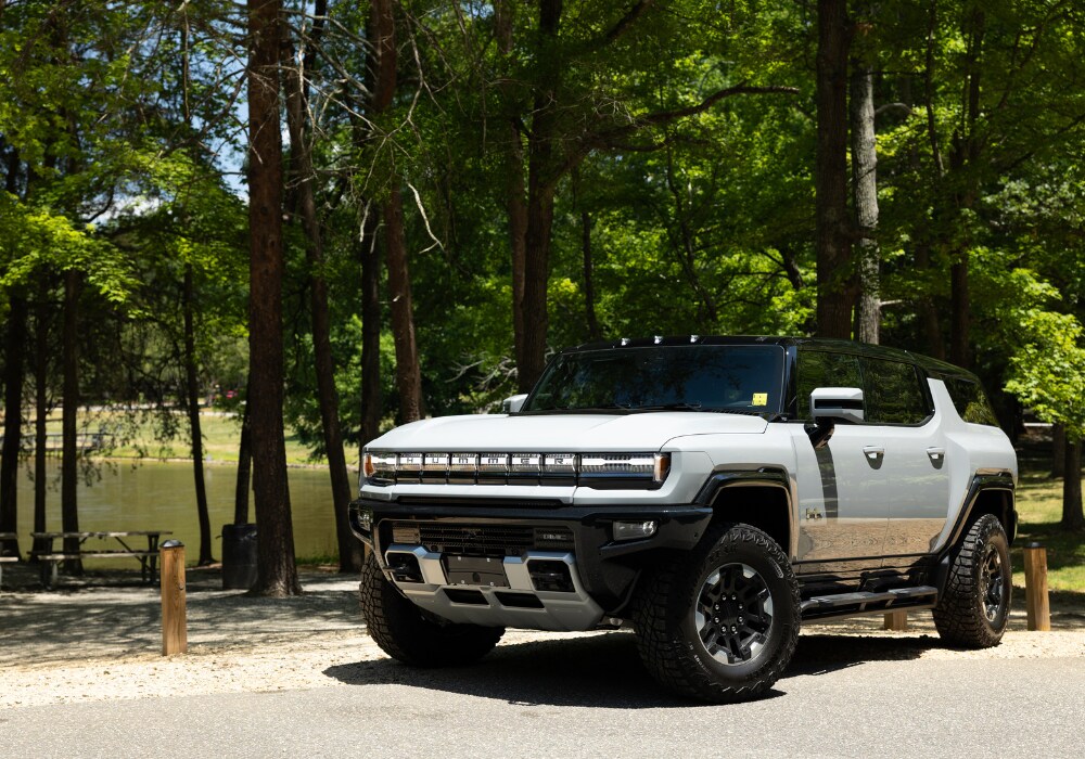 gmc-ev-hummer-for-sale.png Gray 2024 Hummer EV parked in front of a lake and trees in Greensboro, North Carolina