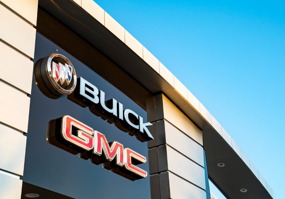 used-gmc-buick-cars-for-sale-greensboro.png Close up shot of the Buick and GMC logos on the front of the Flow Buick GMC Greensboro dealership