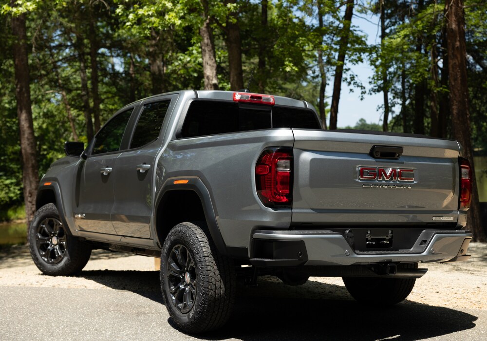 2024-gmc-canyon-pickup-truck.png Gray 2024 GMC Canyon pick up truck with trees in the background