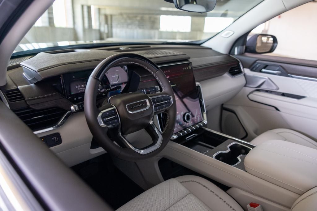 gmc-acadia-denali-greensboro-nc%20(4).jpg Interior shot of a GMC Acadia with infotainment system and white leather seats