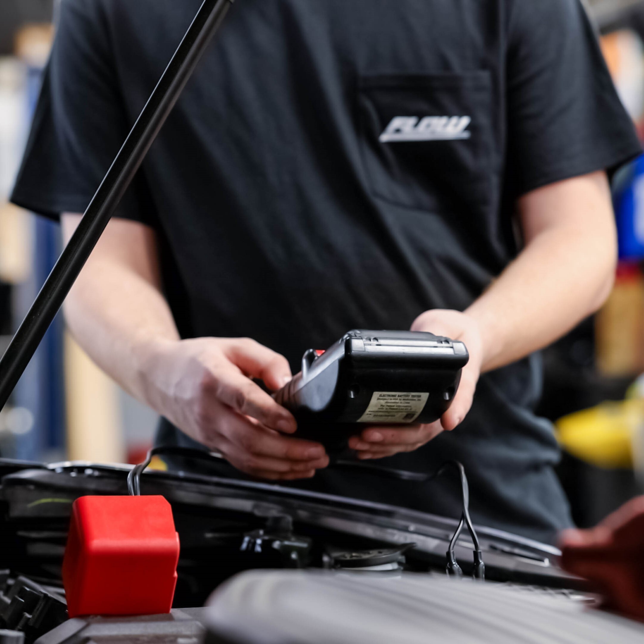 buick-gmc-service-greensboro.jpg fast and efficient service technicians servicing a vehicle at Flow Buick GMC dealership in Greensboro, NC.