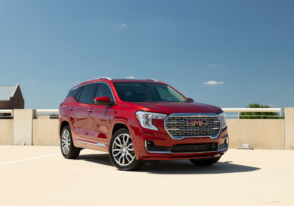 gmc-terrain-for-sale.png Red 2024 GMC terrain parked on top of a parking deck