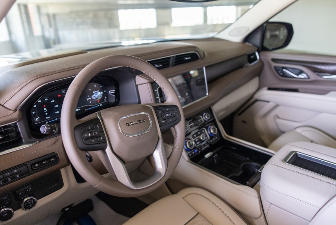 gmc-yukon-interior-2024.png Interior of a GMC Yukon for sale at Flow Buick GMC. The Yukon interior is comprised or beige leather