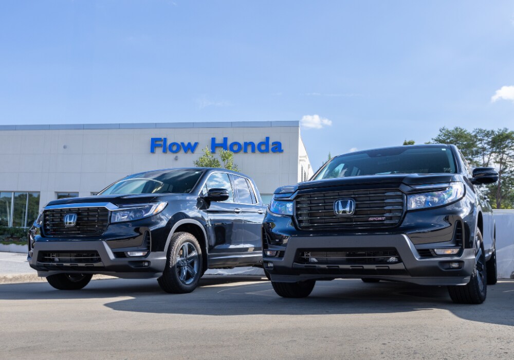 certified-pre-owned-honda-near-high-point-nc.png Two Honda trucks for sale parked outside of the Flow Honda in Winston-Salem dealership