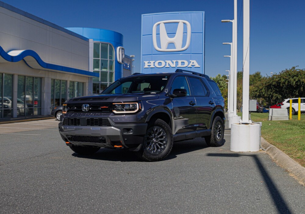 honda-passport-trailsport.png Black Honda Passport Trailsport trim parked in front of a Honda dealership