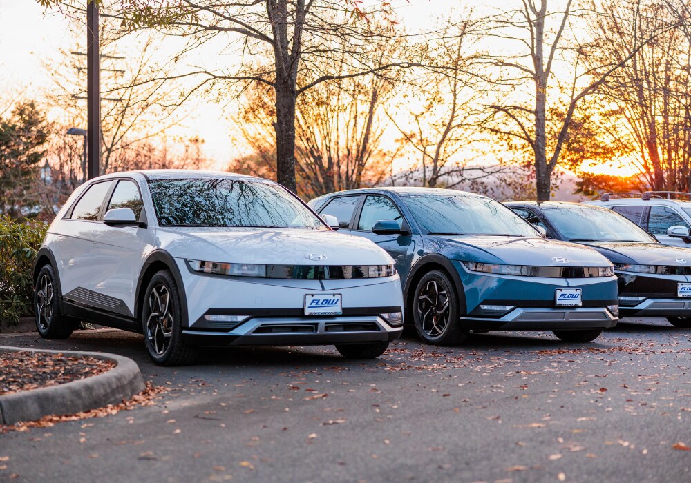 hyundai-certified-pre-owned-cars-charlottesville.png Lineup of Hyundai cars parked in a paved lot with a sunset in the background