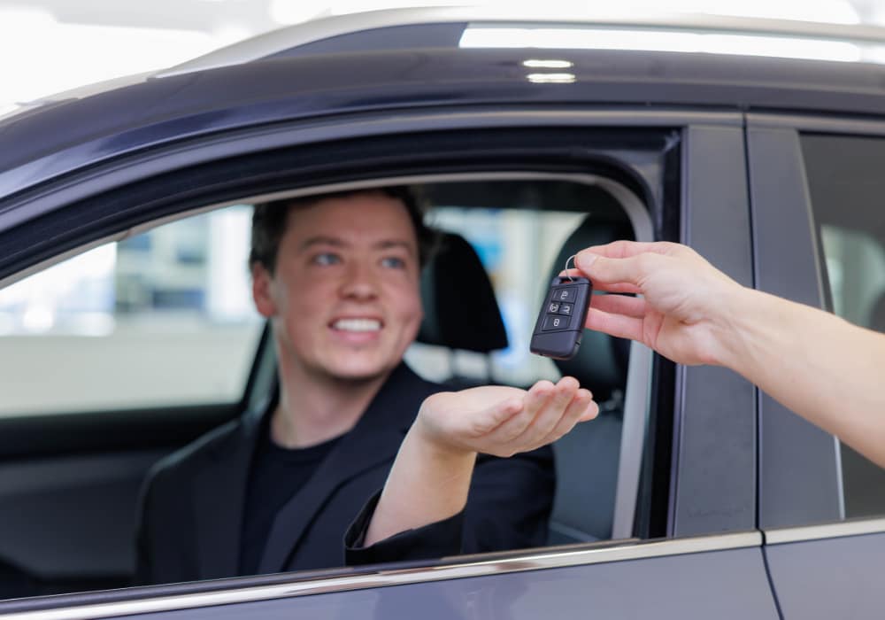 hyundai-kia-test-drive.png Photo shows a key being passed to a man sitting in driver's seat of a car at Flow Hyundai of Statesville
