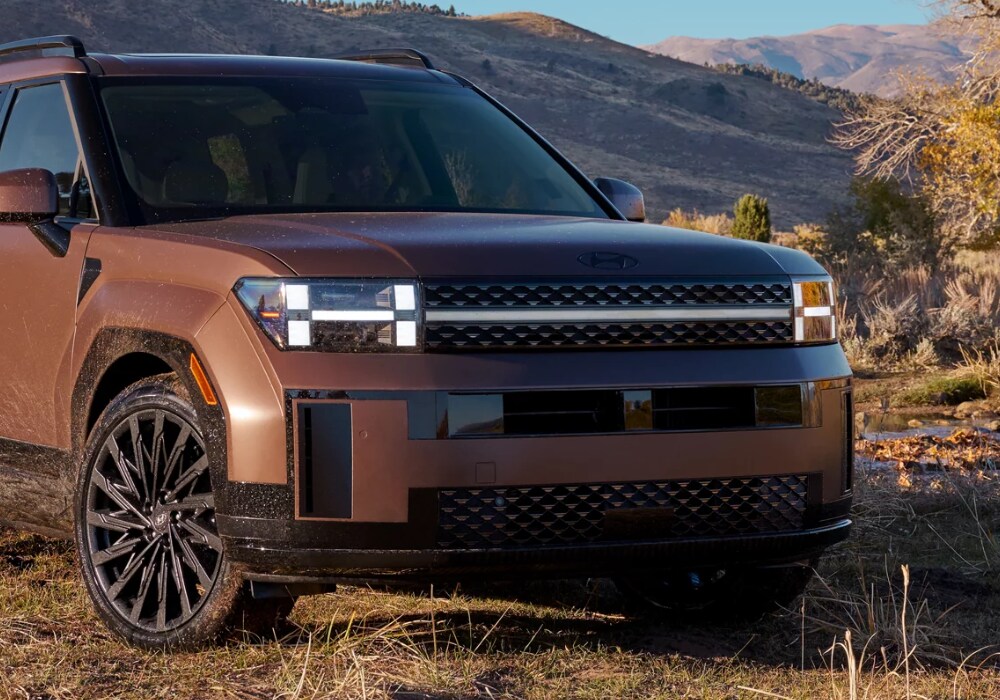 2024-hyundai-santa-fe-for-sale.png Brown 2024 Hyundai Santa Fe parked in front of mountains