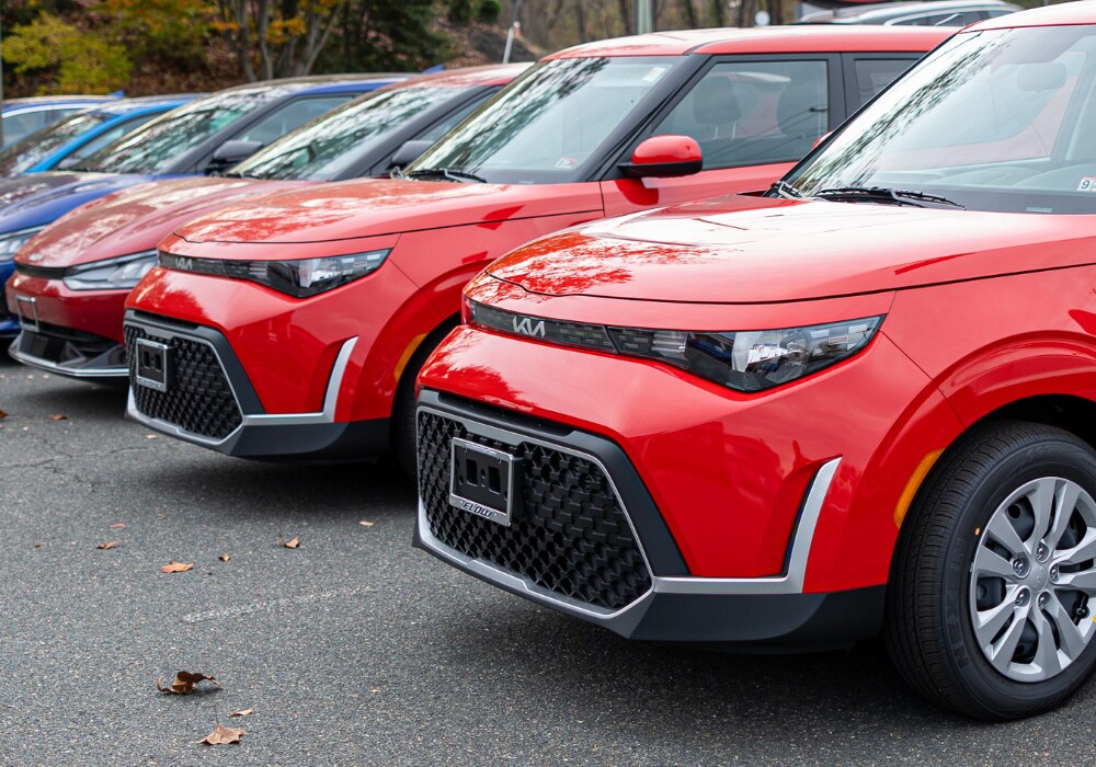 kia-certified-pre-owned-cars-charlottesville.png Lineup of red Kia SUVs parked in the lot of Flow Kia of Charlottesville
