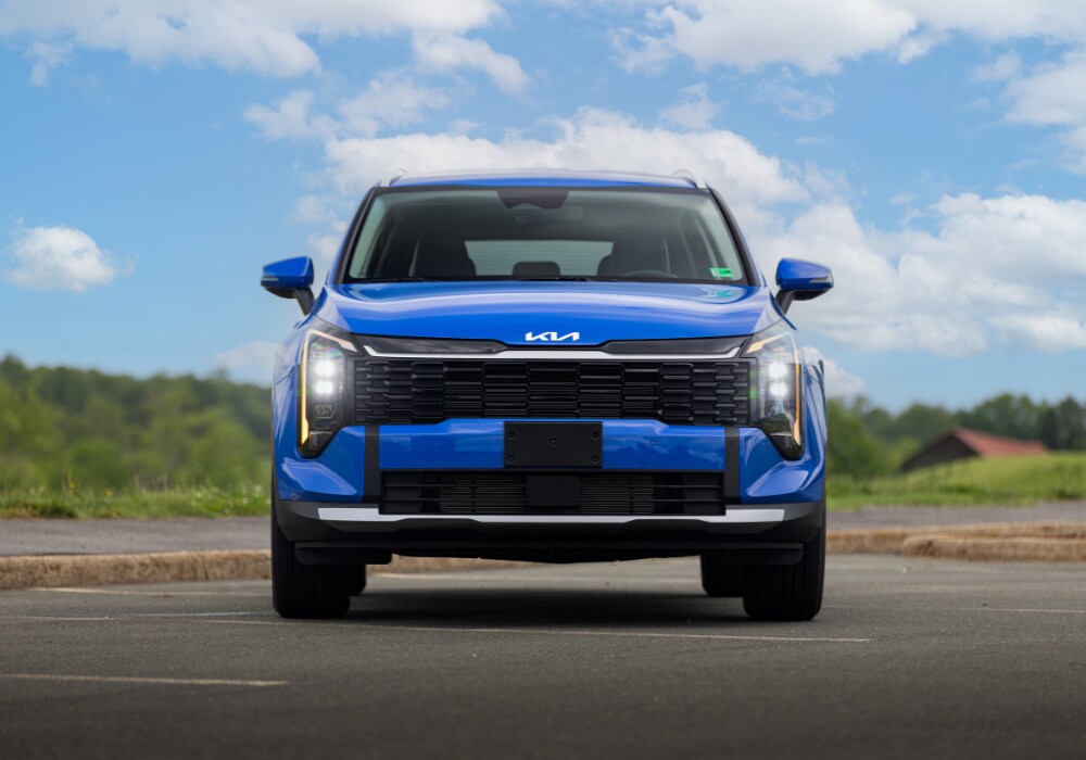 2025-kia-sportage-suv.png 2025 Kia Sportage with its headlights on facing the camera