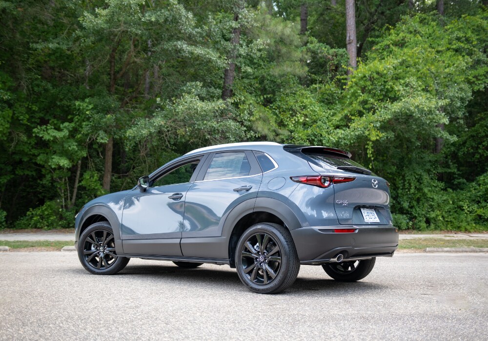 cx-30-mazda-2024.png Blue 2024 Mazda Cx-30 for sale in Charlottesville. Car is parked in front of trees
