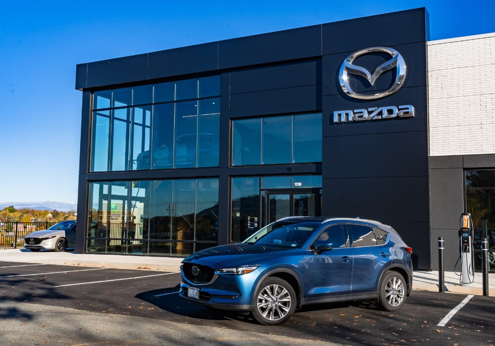 certified-pre-owned-mazda-charlottesville-va.png Mazda SUV parked in front of a Mazda dealership in Charlottesville, VA
