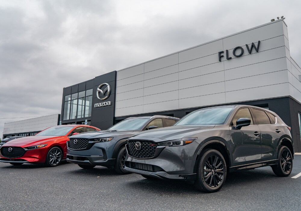 mazda-dealership-near-fort-bragg.png Lineup of a few Mazda cars parked in front of the Flow Mazda of Fayetteville dealership