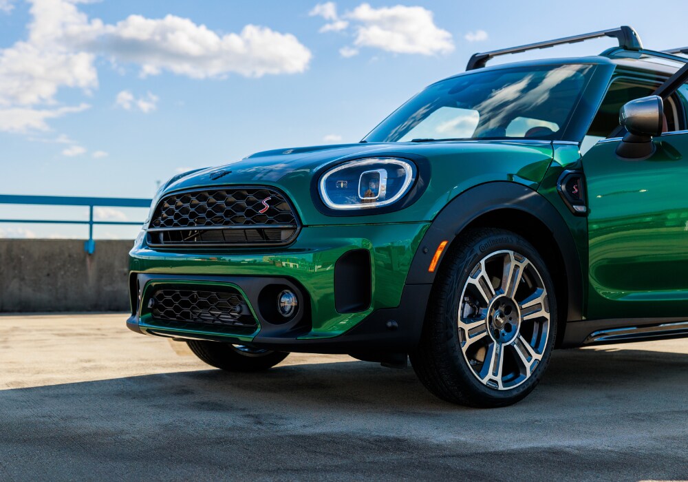 mini-countryman-for-sale-near-me.png Front half of a MINI Countryman. The car is in the color British Racing Green