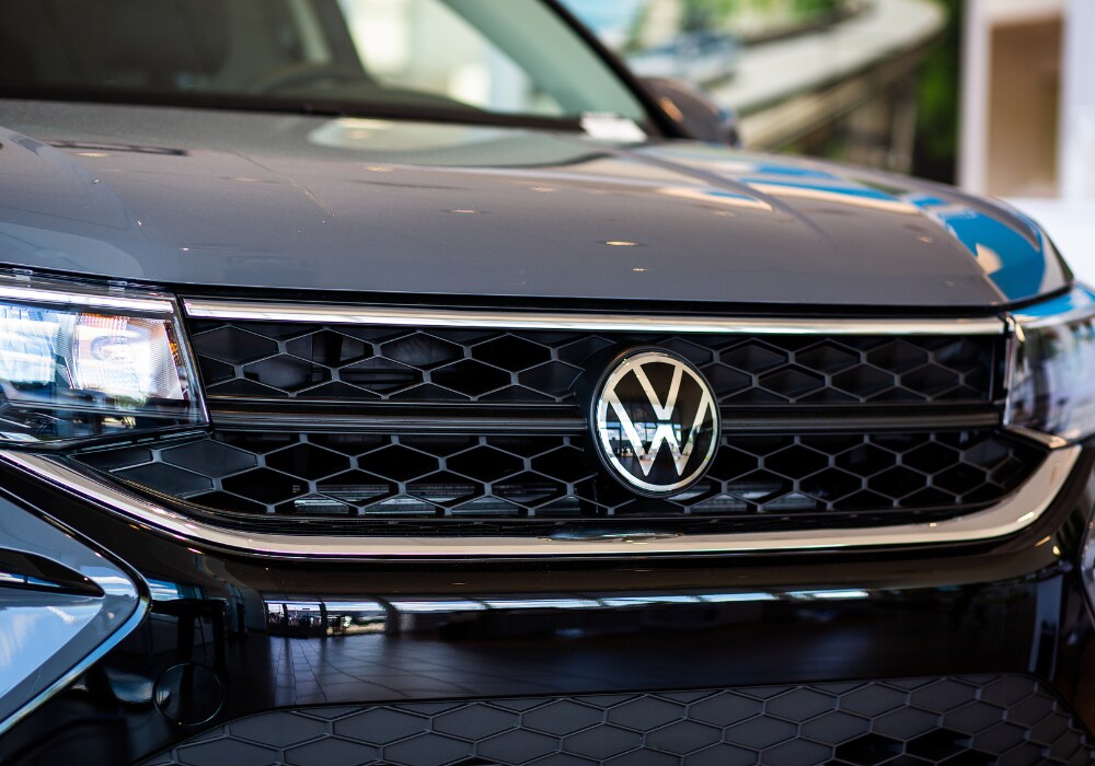 new-volkswagen-for-sale-greensboro.png Close up photo of the front grille of a Volkswagen SUV. The VW logo is attached to the center of the grille