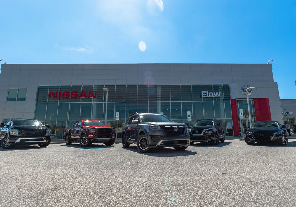 nissan-demo-vehicles-fayetteville-nc.png Lineup of Nissan cars for sale parked in front of the Flow Nissan of Fayetteville dealership