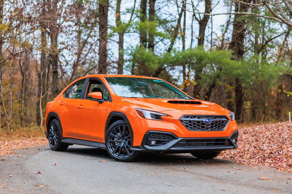 flow-subaru-wrx-burlington-greensboro.jpg Subaru WRX for sale, shown in orange, pictured amongst a wooded setting