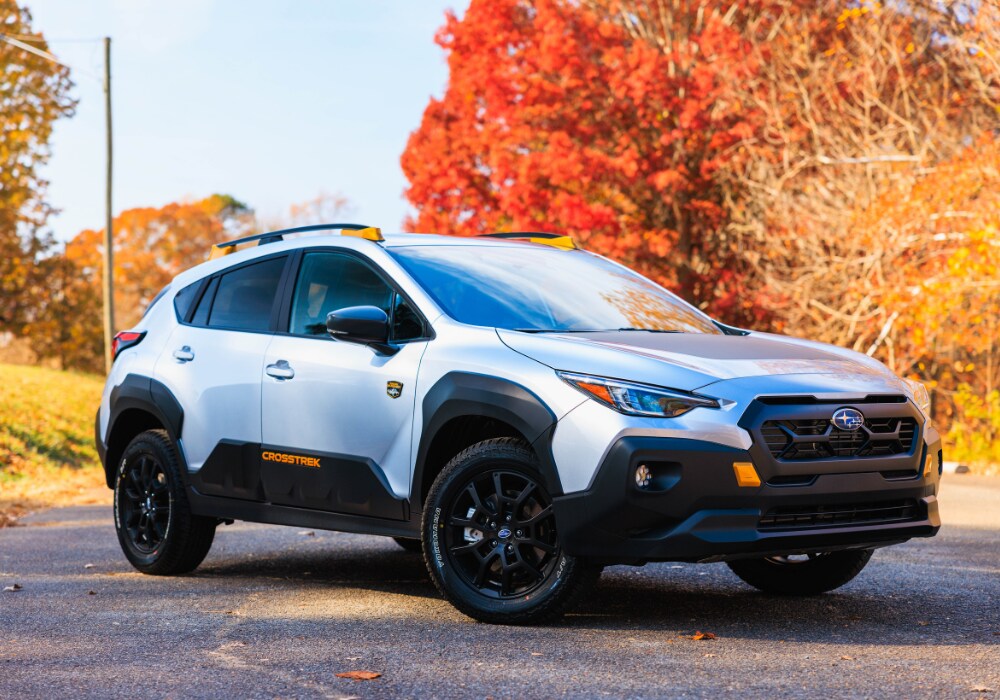 subaru-demo-vehicles-burlington-nc.png White Subaru Crosstrek for sale parked in front of trees with orange leaves